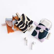 Load image into Gallery viewer, A collection of puffy AirPod cases in various designs and colors, displayed alongside a pair of AirPods.