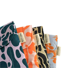 画像をギャラリービューアに読み込む, Product photo of fabric latop pouches, close up on corner of 4 cases each in a different abstract colourway