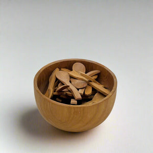 Product photo of miniature wooden spoons. Multipal miniature spoons in a wooden bowl.