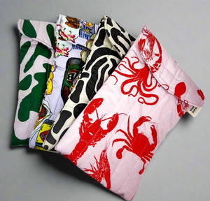 Product photo of fabric Ipad pouchs, four cases fanned out in different bright abstract prints