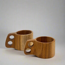 Load image into Gallery viewer, Product photo of two wooden mugs, with double circle handles. Once Large on Small 
