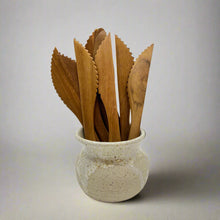 Load image into Gallery viewer, Product photo of wooden knives with a serrated edge. Multipal knives in a ceramic vase
