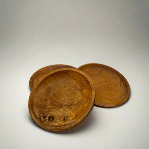 Product photo of wooden plates, three plates sitting in a circle