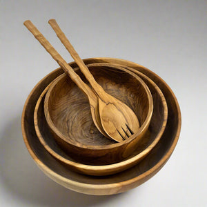 Product photo of wooden salad bowls. Three bowls, Small, Medium and Large stacked with a set of salad servers sitting ontop