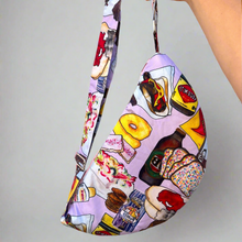 Charger l&#39;image dans la galerie, Product photo of fabric sling style bag, in colourful print showing icon Australian Foods. Hand is holding up bag by a long strap
