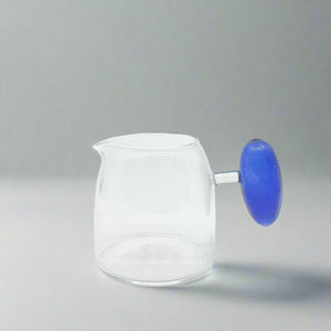 product photo for a small glass milk jug with a statement round blue handle