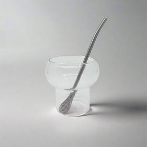 product photo of a small glass cup and stainless steel straw with strainer end