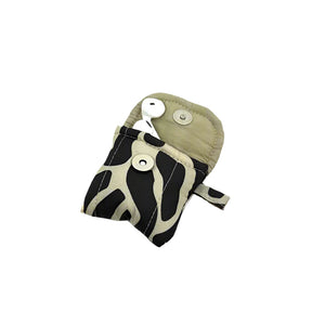 product photo of fabric airpod pouche, open at top to show inside. Black and beige abstract print