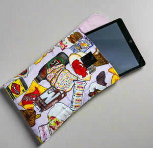 Product photo of fabric Ipad pouch. Top is open to show where ipad fits. Bright print of Iconic Austrlian Foods