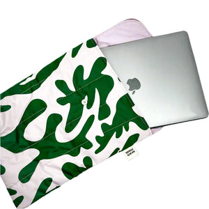 Product photo of puffy laptop bags, bag open to show laptop fitting. Print and Green abstract print