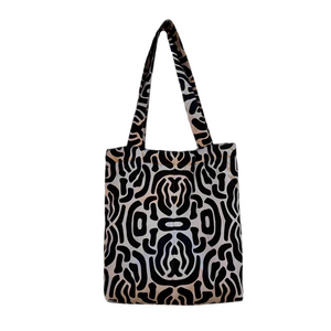 product photo for puffy fabric tote bag. Black and beige mirrored abstract print