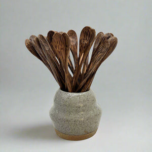 Product photo for Long Handled wooden spoons. Multiple spoons sitting in ceramic vase