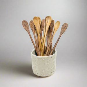 Product photo of long handled wooden spoons. Multipal spoons sitting in a ceramic cup