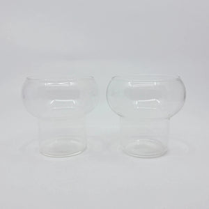 product photo of two glass cups. with a rounded bulb top and cylindrical bottom 