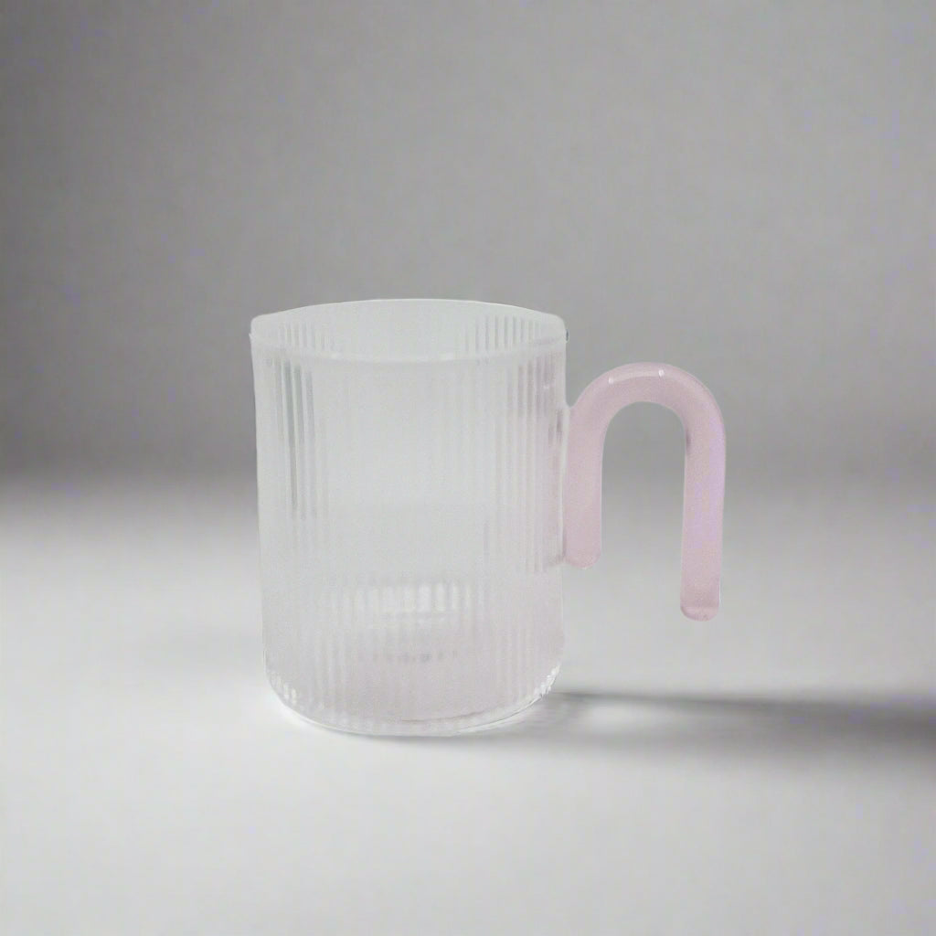 product photo of a glass mug. Clear with a pale pink handle