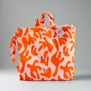 product photo for puffy fabric tote bag. Bright orange and pastel pink bag with handle